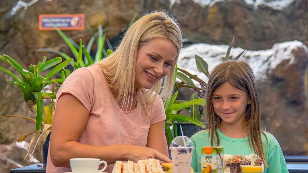 Mother and daughter enjoying snacks at SEA LIFE Sunshine Coast café.