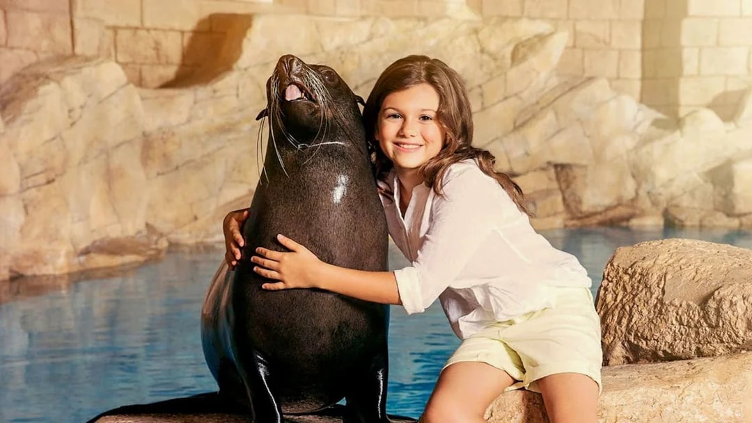 Girl hugging sea lion at Aquaventure Waterpark.