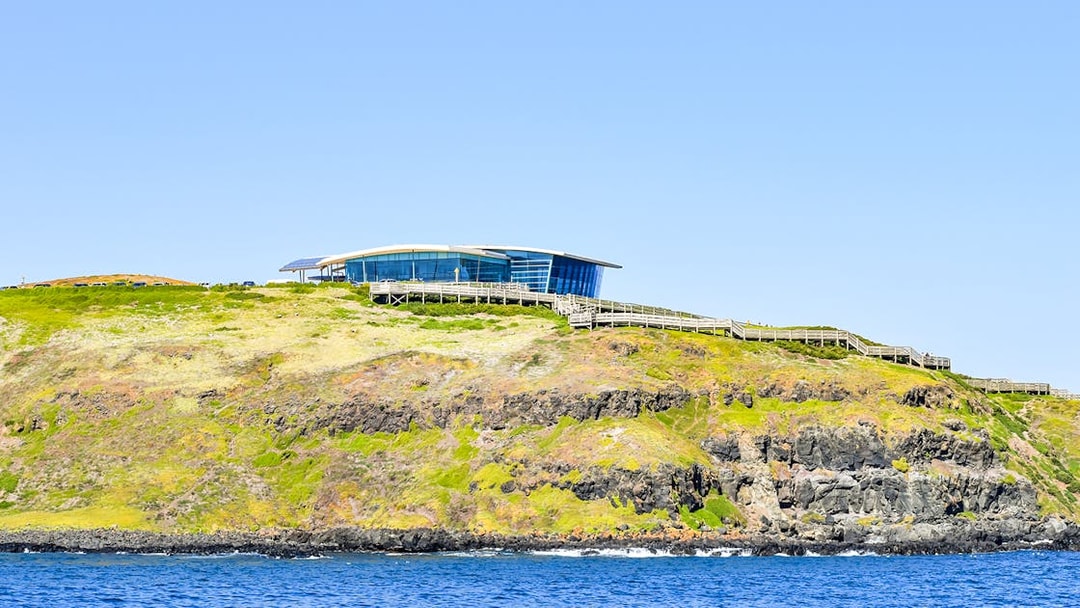 Phillip Island visitor center on a cliff overlooking the ocean, seen from the Seal Watching Afternoon Cruise.
