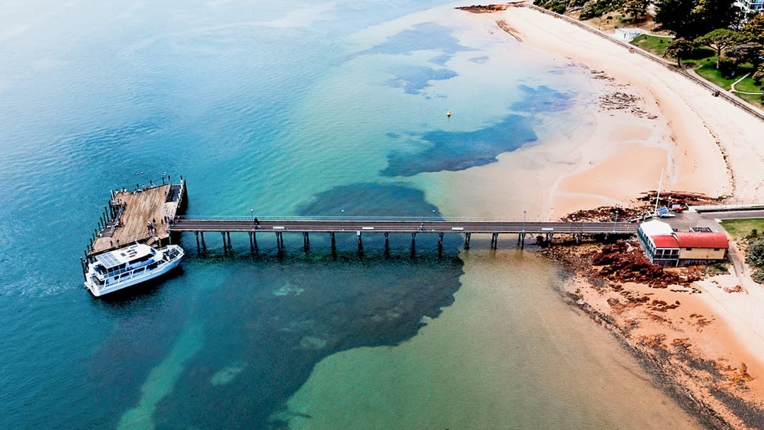Phillip Island pier with cruise boat docked for seal watching tour.