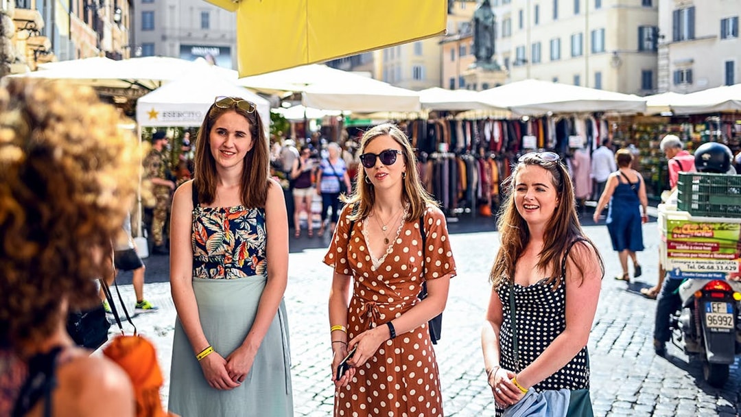 Women exploring a market in Rome during a food tour.
