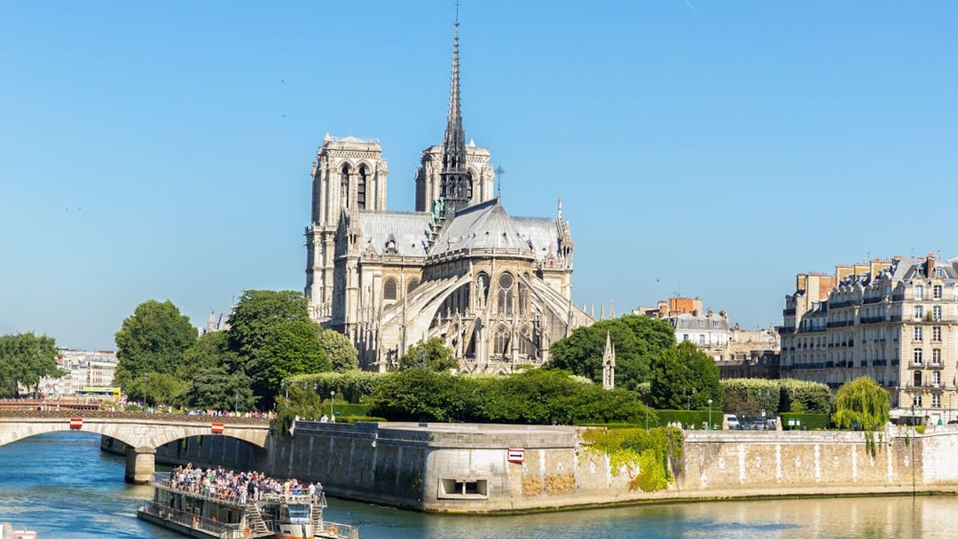 Cruise ship on Seine River passing Notre Dame Cathedral, Paris.