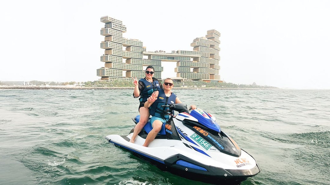 Tourists on jet ski near Atlantis The Royal, Dubai.