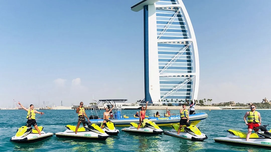 Tourists on jet skis near Burj Al Arab in Dubai.