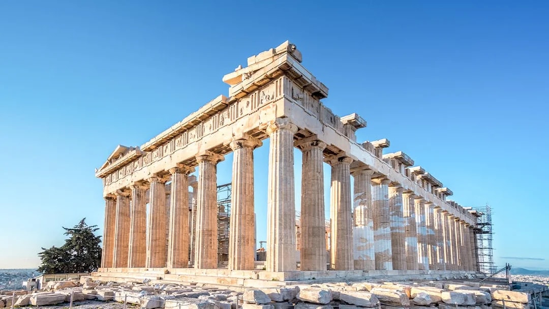 Parthenon temple on the Acropolis in Athens, Greece under a clear blue sky.