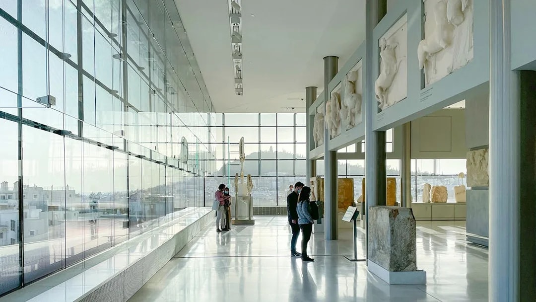 Visitors exploring sculptures inside Acropolis Museum, Athens.