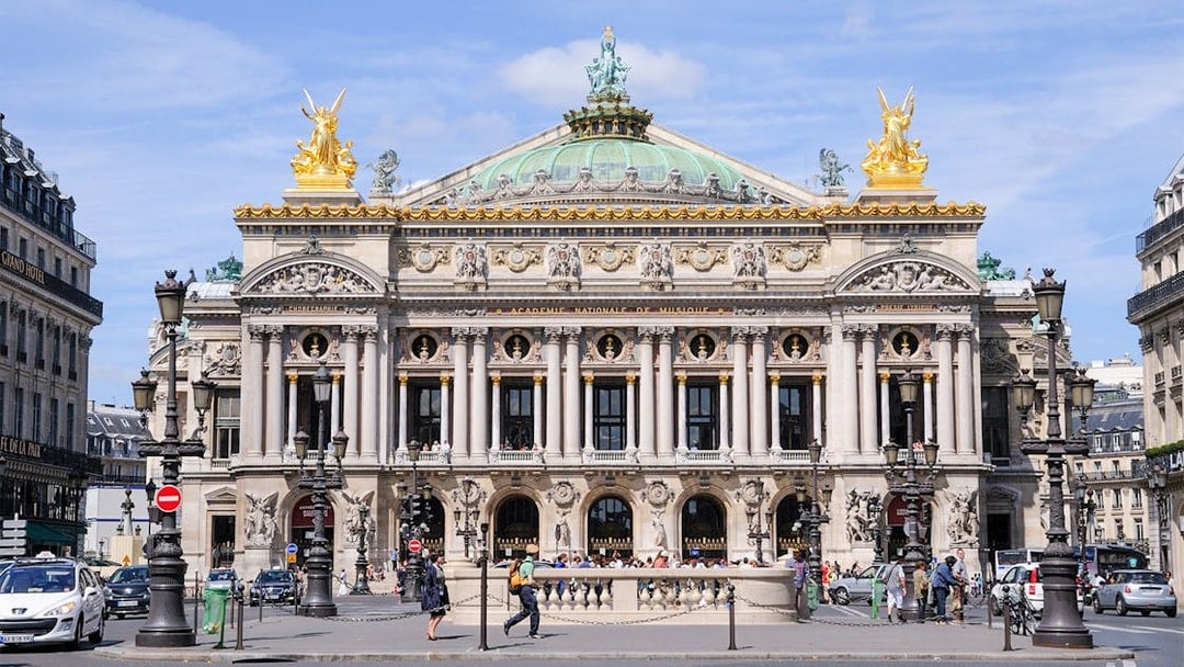 Opera Garnier facade in Paris with ornate architecture and golden statues.