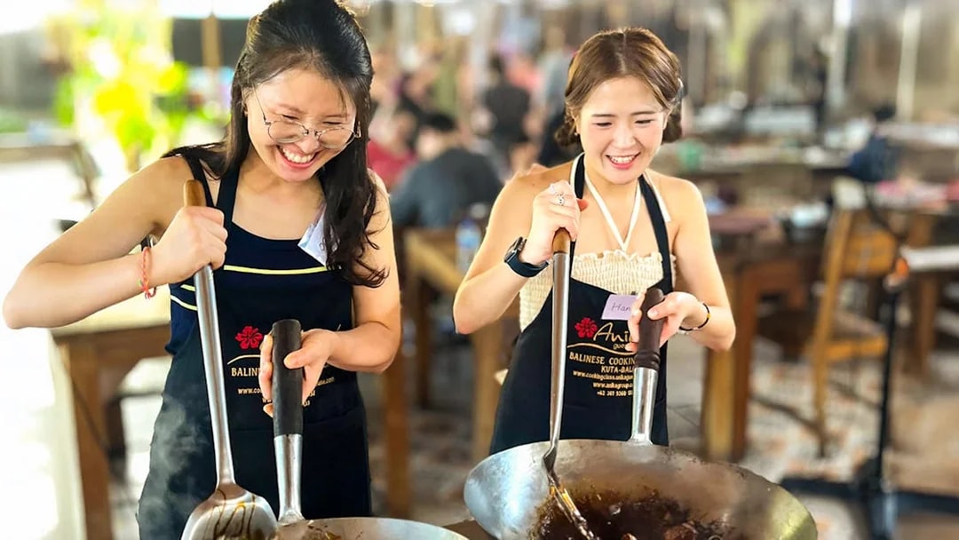 Participants cooking at Nia Balinese Cooking Class in Bali.