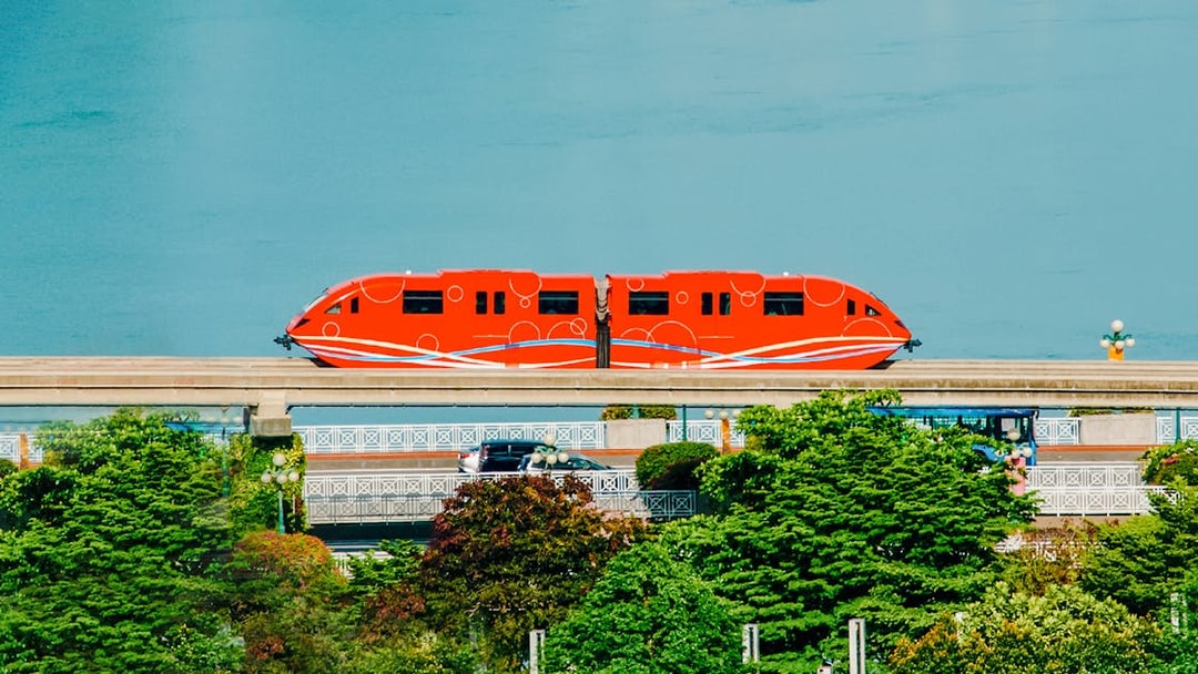 Red monorail traveling on Sentosa Island, Singapore.