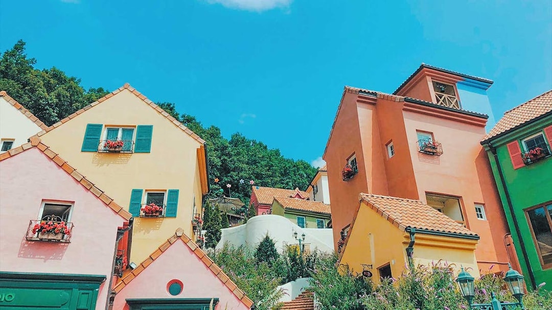 Colorful houses in Petite France & Italian Village with vibrant facades and flower boxes.