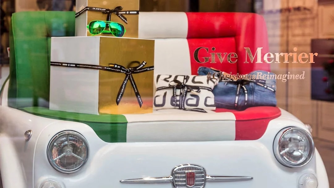 Serravalle Designer Outlet display with Italian-themed gifts and Fiat car seat.
