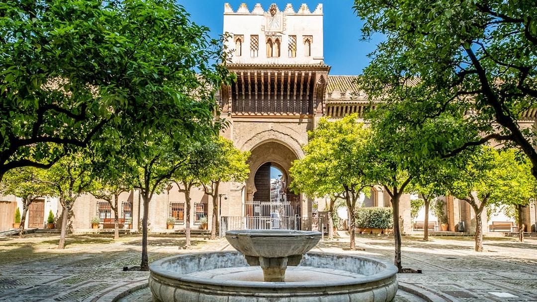 Courtyard with fountain and orange trees at Cathedral and Giralda Tower, Seville.