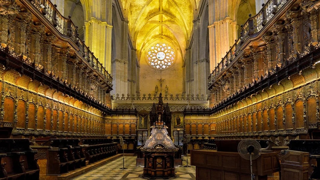 Chapel interior with ornate wooden choir stalls in Cathedral of Sevilla, Spain.
