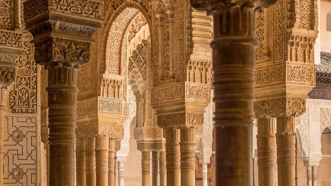 Intricate Moorish arches and columns in the Alhambra, Granada.