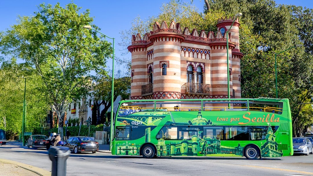 Sevilla hop-on hop-off bus passing Costurero de la Reina.