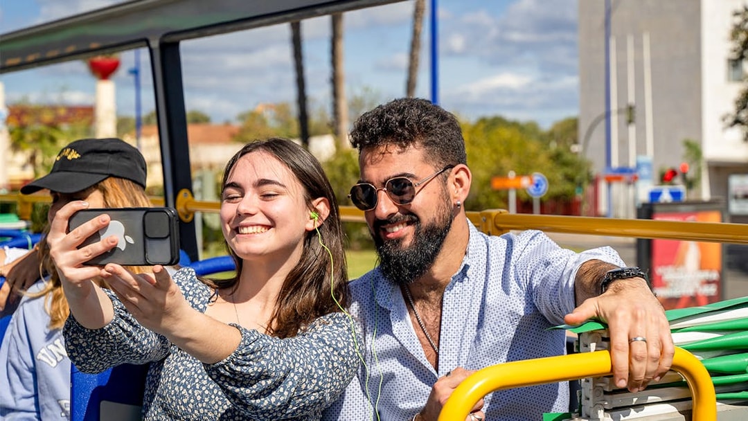 People taking a selfie on a Seville hop-on hop-off bus tour.
