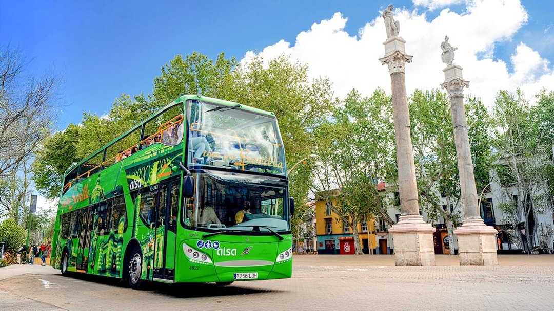 Hop on hop off tour bus near La Alameda columns, Seville.