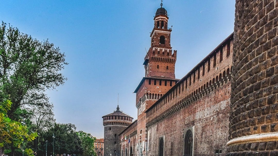 Sforza Castle exterior with tower and brick walls, Milan, Italy.