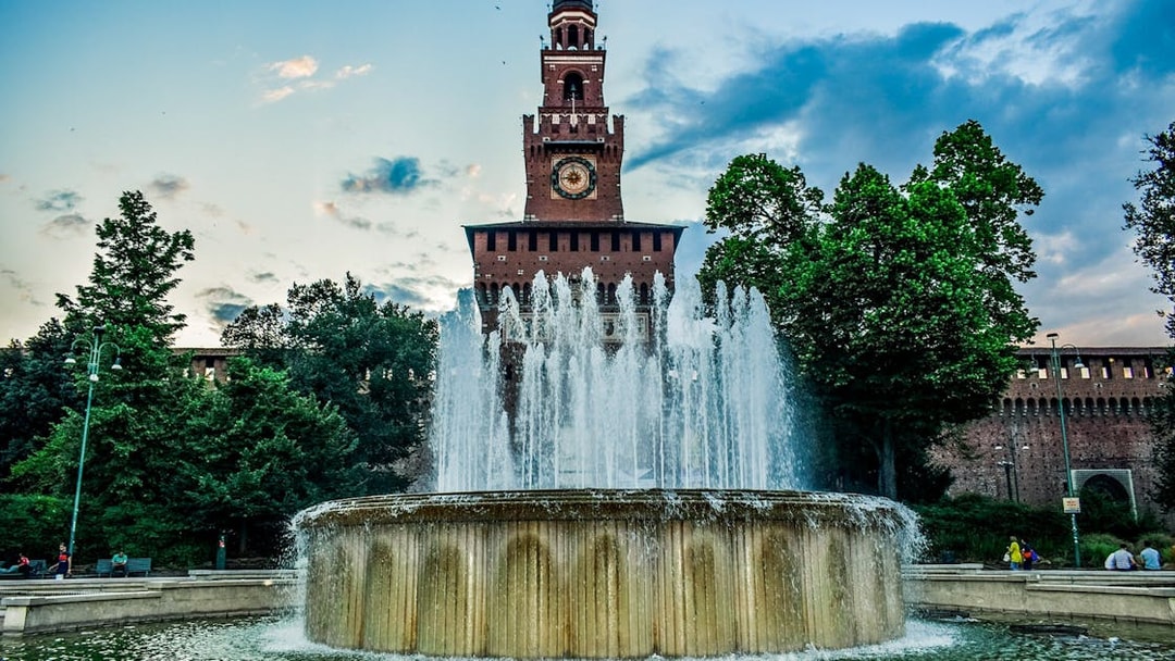 Sforza Castle entrance with fountain in Milan, Italy, during a self-guided tour.