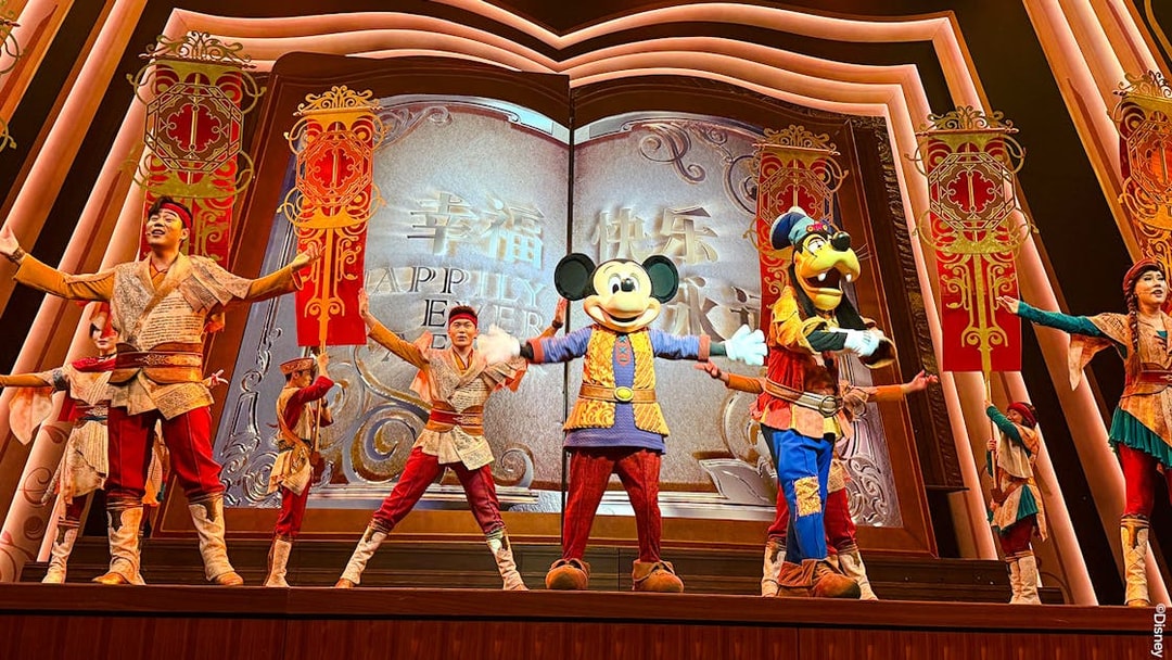 Mickey Mouse and performers on stage at Shanghai Disney show.