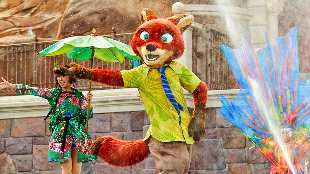Character performance at Shanghai Disney with colorful costumes and water effects.