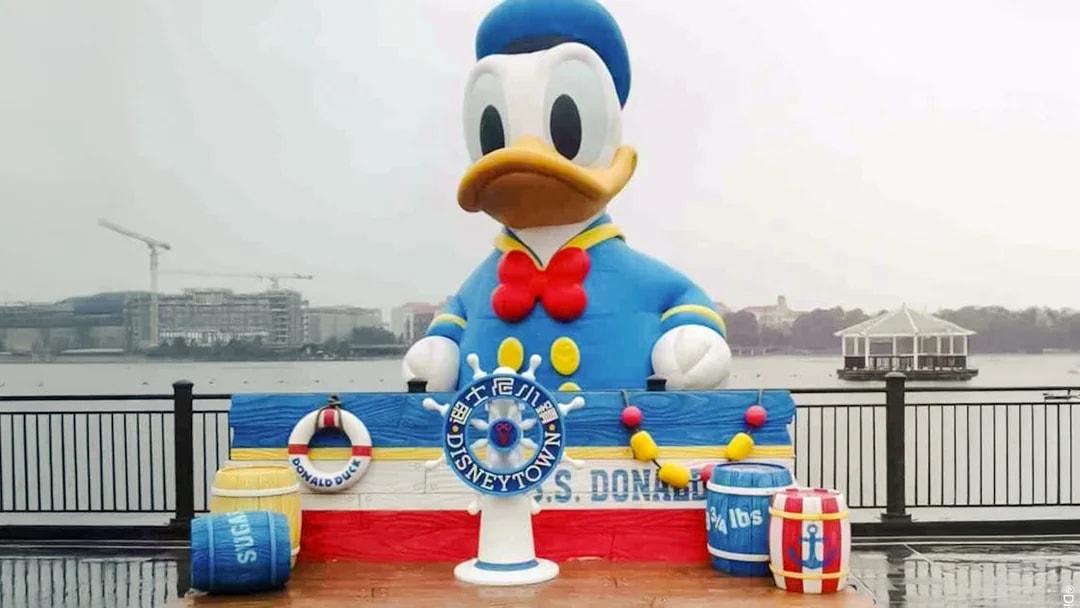 Donald Duck statue at Disneytown, Shanghai Disneyland, with waterfront view.