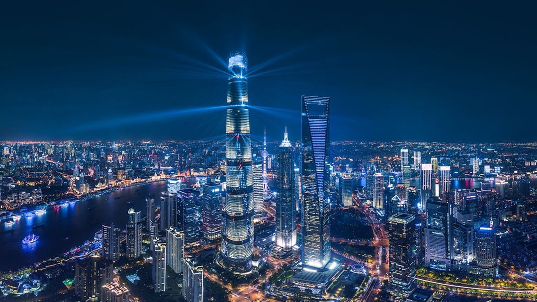 Panoramic night view of Shanghai skyline with illuminated skyscrapers from Shanghai Tower.