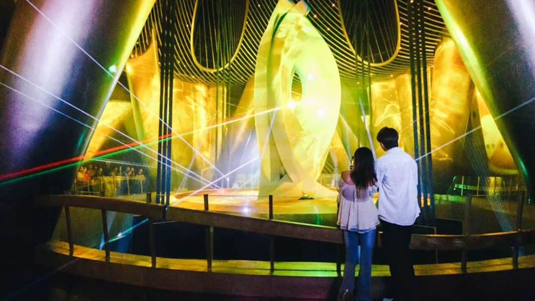 Visitors observing a light display inside Shanghai Tower.