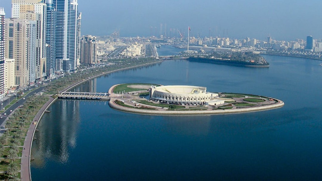 Sharjah skyline and Al Majaz Amphitheatre viewed from the water on a Hop-On-Hop-Off Bus Tour.