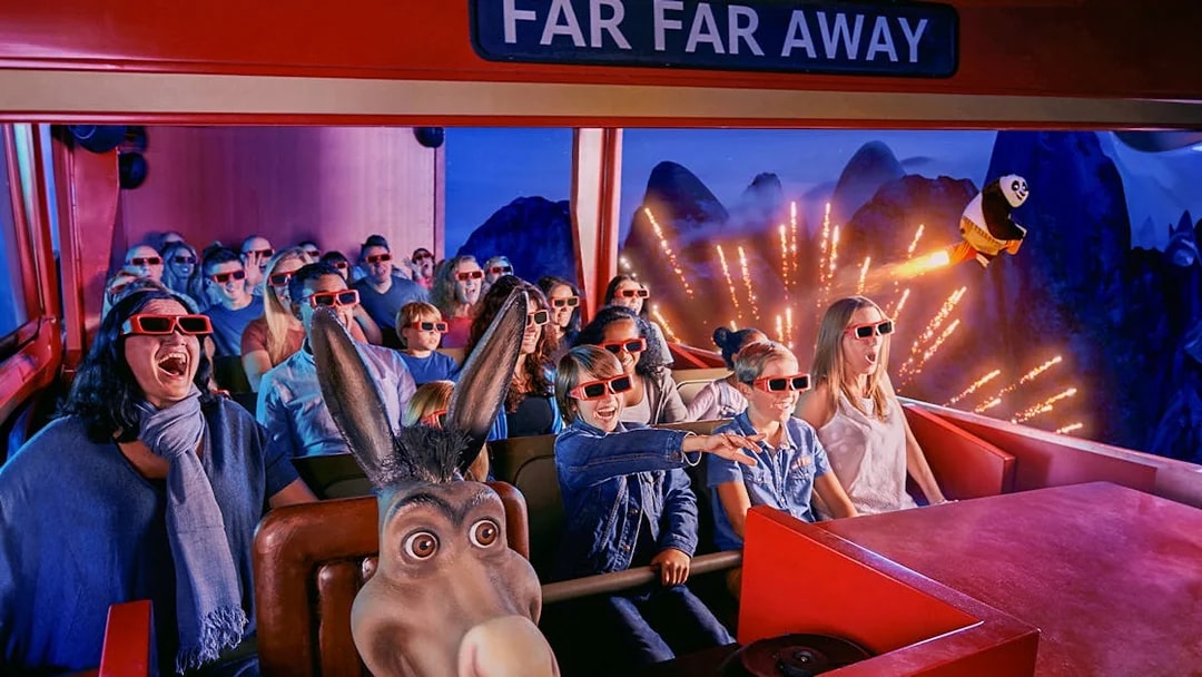Visitors enjoying a 4D ride at Shrek’s Adventure! London with 3D glasses and animated effects.