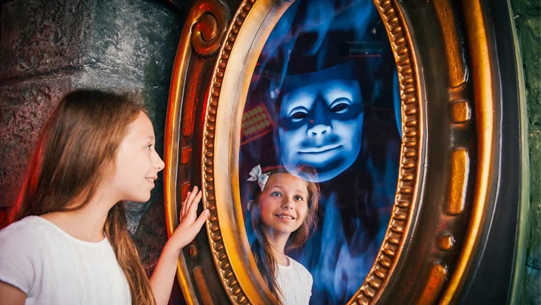 Child interacting with magic mirror at Shrek’s Adventure! London.