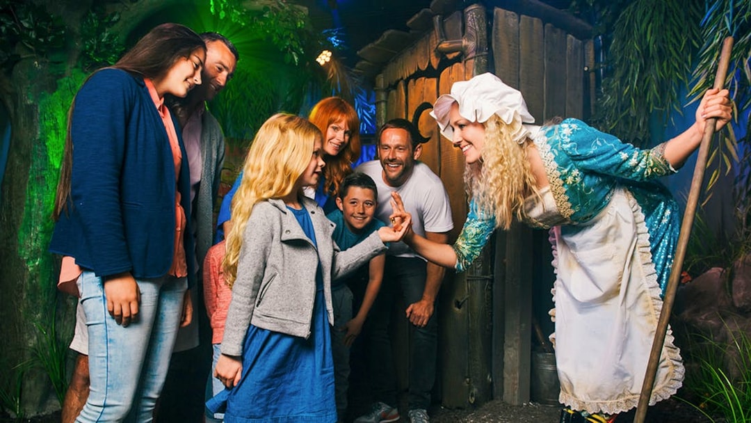 Group interacting with a costumed character at Shrek’s Adventure! London.