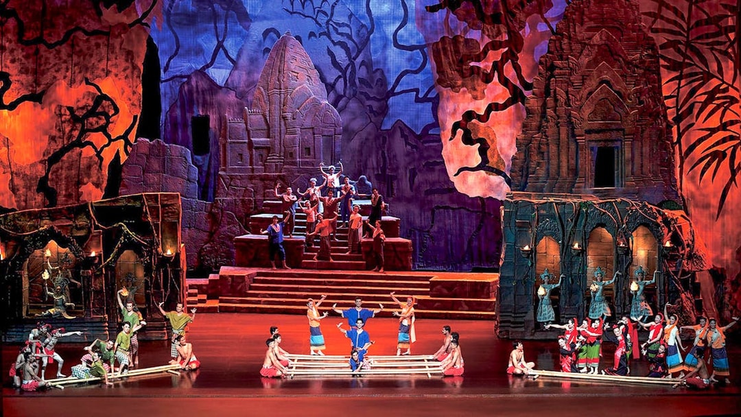 Performers on stage at Siam Niramit Phuket, depicting a cultural scene with traditional costumes.