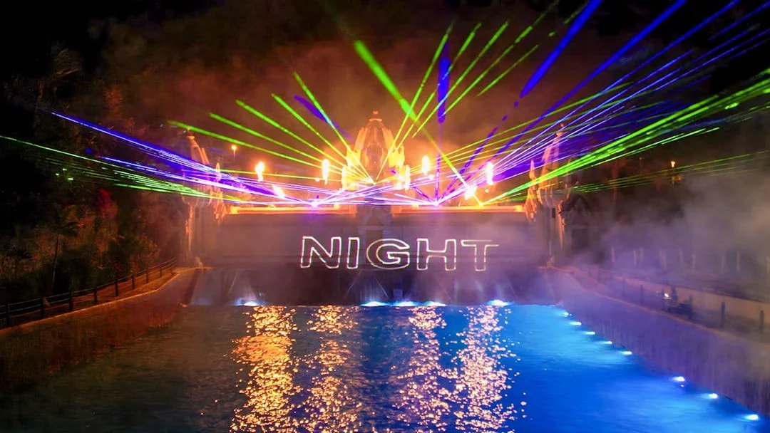 Laser show over water at Siam Park at night.