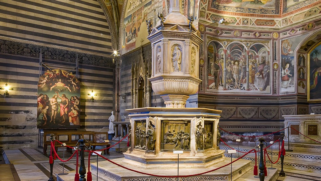 Siena Duomo interior with ornate pulpit and frescoes, part of OPA SI Pass tour.