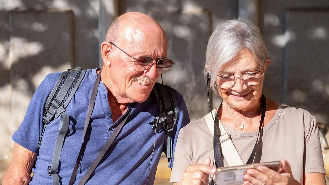 Tourists using audio guide in Paris's Latin Quarter with OPA SI Pass.