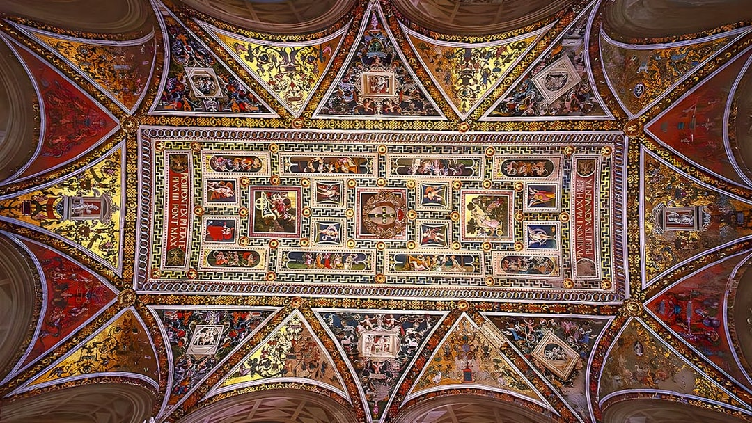 Ceiling frescoes of Siena Cathedral, Italy, showcasing intricate religious artwork.