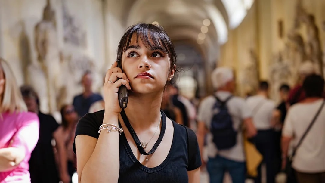 Visitor listening to an audio guide inside Siena Cathedral.