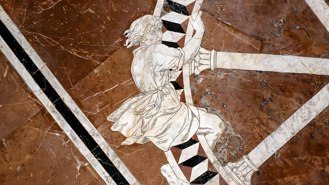 Marble inlay artwork on Siena Cathedral floor depicting a historical figure.