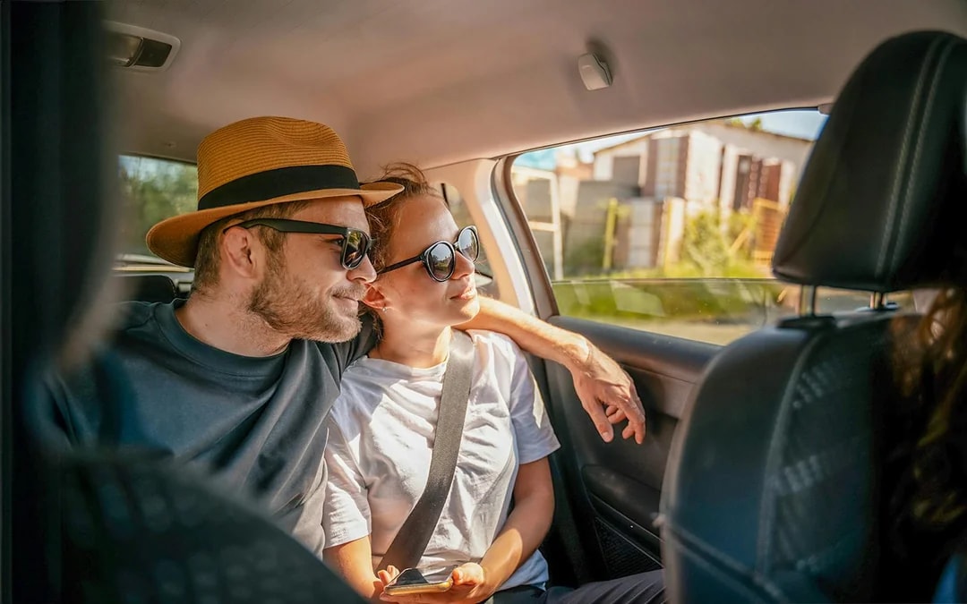 Tourists in a car enjoying a scenic drive, part of Similan Islands tour with hotel transfers.