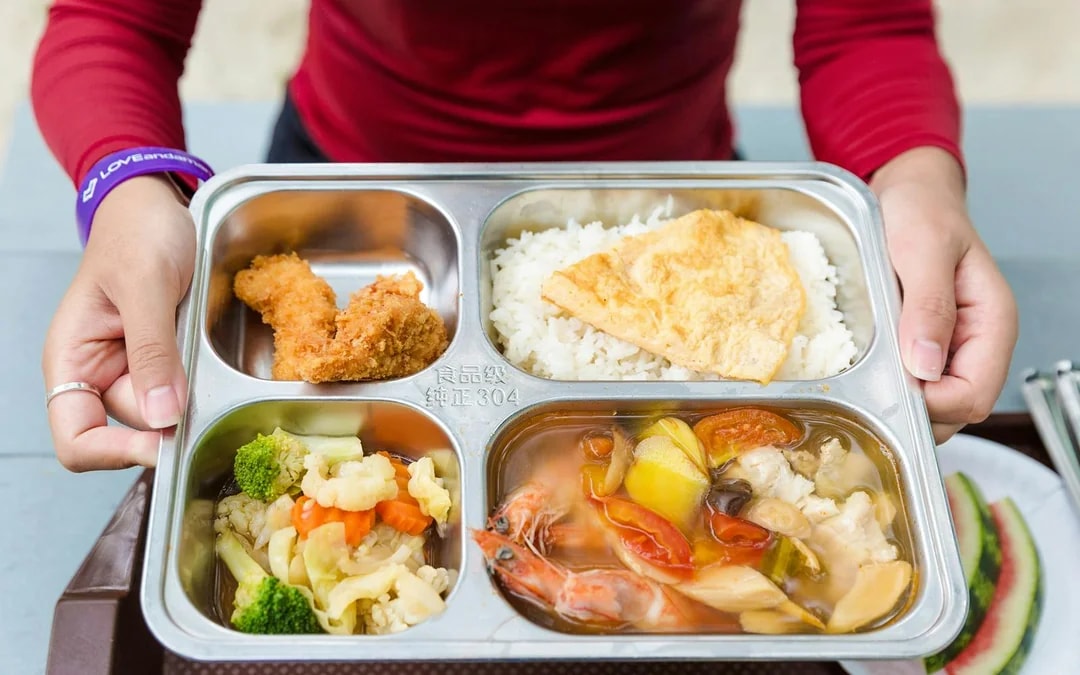 Buffet meal with rice, fried chicken, vegetables, and seafood soup on Similan Island.