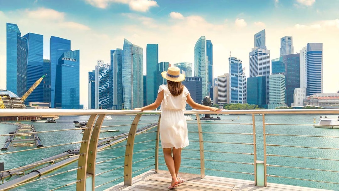 Woman overlooking Marina Bay Sands skyline in Singapore.