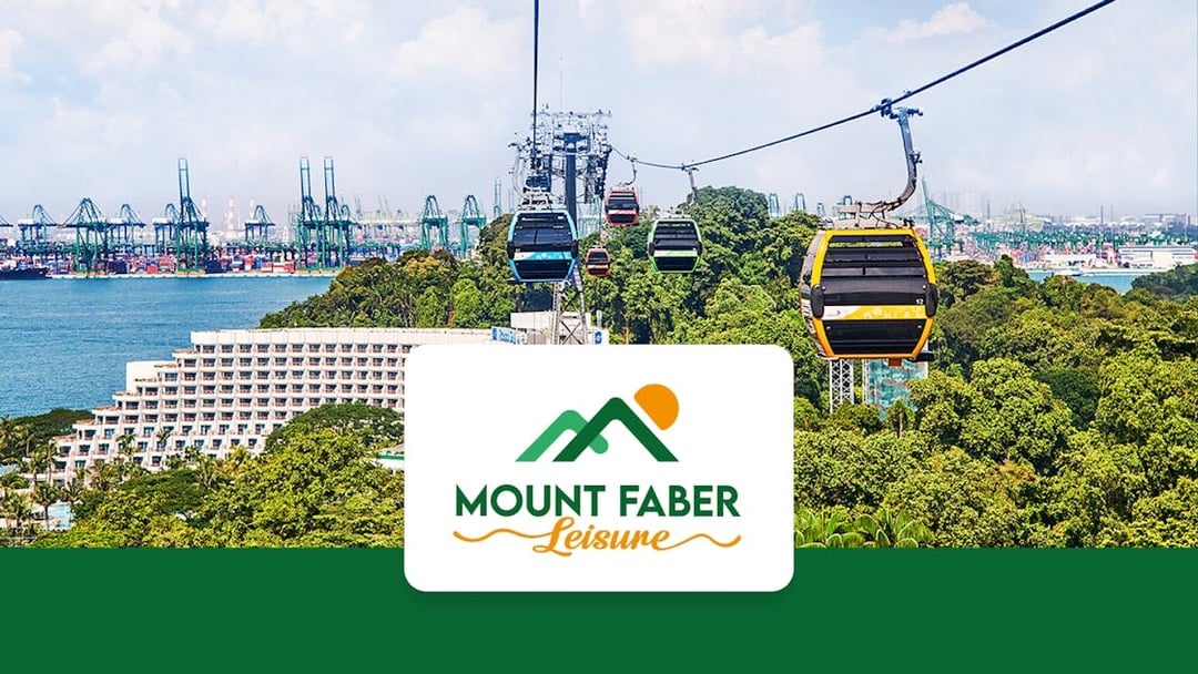 Singapore Cable Car over lush greenery with city skyline in the background.