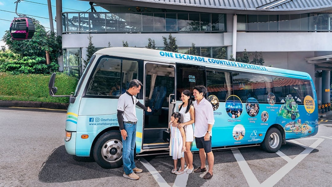 Family boarding tour bus near Singapore Cable Car station.