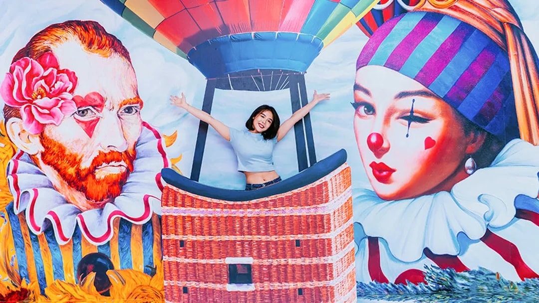 Woman posing in front of colorful mural with hot air balloon, Singapore Cable Car Flexi Pass.