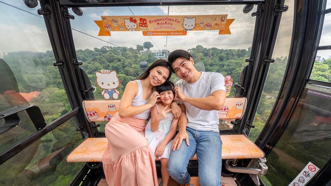 Family enjoying Singapore Cable Car with Hello Kitty theme.