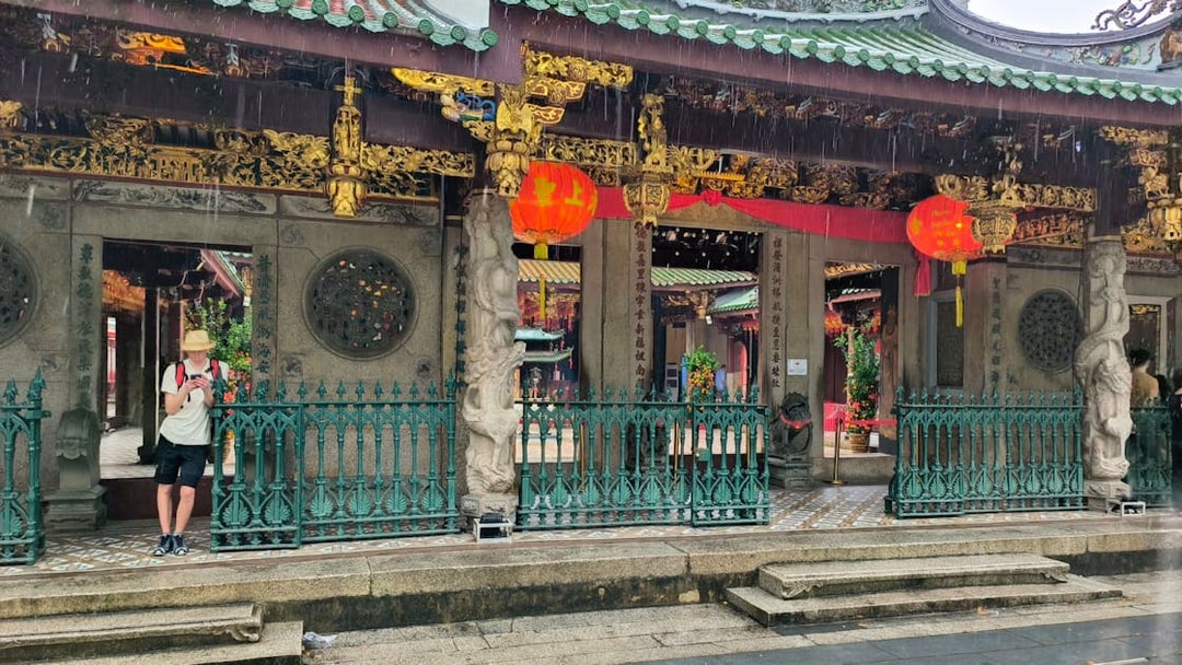 Chinatown temple entrance with red lanterns during Singapore City Tour.