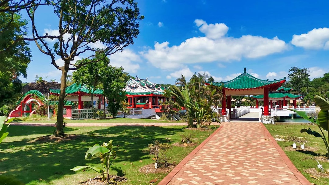 Kusu Island temple with green roofs and red pillars, Singapore.