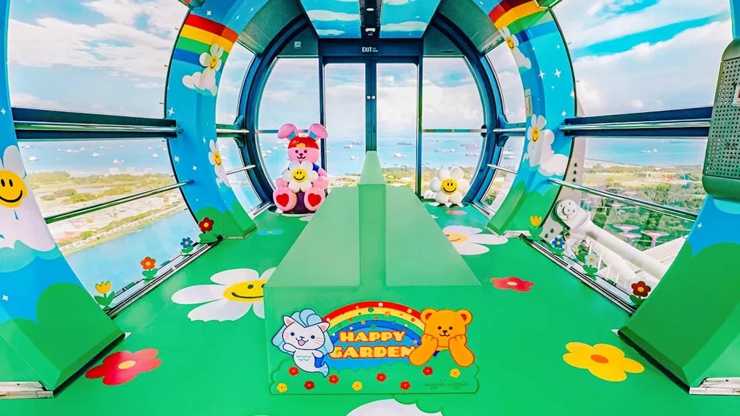 Singapore Flyer capsule interior with colorful cartoon decor and city view.