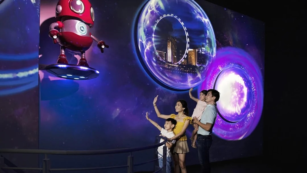 Family exploring interactive display inside the Time Capsule, Singapore.